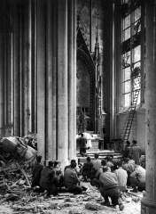 RESCANDate taken: 4/1945Description: American soldiers w. rifles kneeling to pray amidst bombing rubble in the main body of Cologne Cathedral as an Army chaplain holds first mass since it bombing on Mar. 2.City: CologneCountry: Germanycr: Margaret Bourke-White/Time & Life Pictures/Getty ImagesOWNED